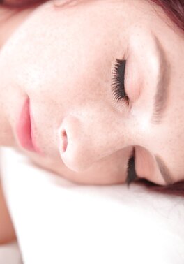 Excited young lady with red hair won't fall asleep until masturbates pussy