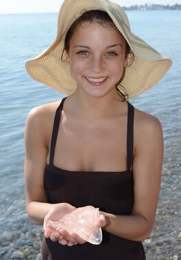 Teen sweetie with freckled face likes to walk without clothes on the beach