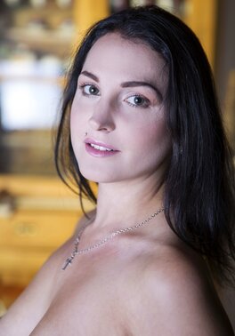 Girl with Monroe piercing and tattooed leg teases males in solo gallery