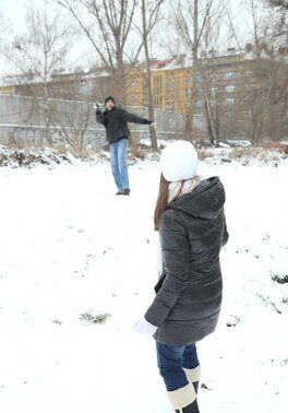 Spicy girl plays in the snow with young man and hurries home to play adult games