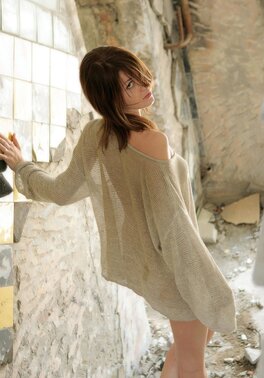 Russian girl with a tattoo on her lower back walks naked in abandoned building