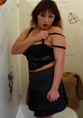 Modest-looking woman gives slobbery blowjob in a bathroom with gloryhole