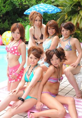 Oriental girlfriends in skimpy bikinis rest half-naked with men poolside