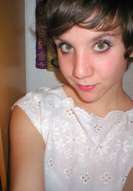 Schoolgirl with small boobs is posing for XXX pics in the bedroom