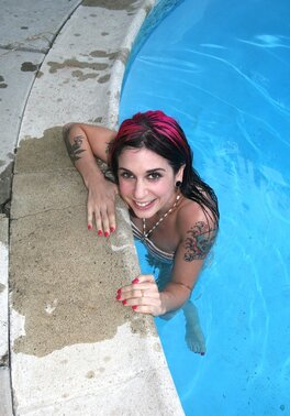 Punk chick Joanna Angel gets naked by the pool with pink hair and a perfectly shaped body
