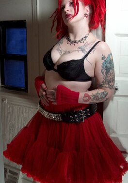 Fetish chick with flaming red hair spreads her chubby pussy wide in the bathroom