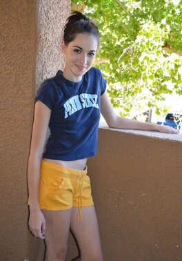 Emily G enjoys pulling her shorts down over her ass on the condo balcony