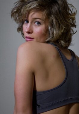 Blonde with big hair shows off her shaved pussy on the floor