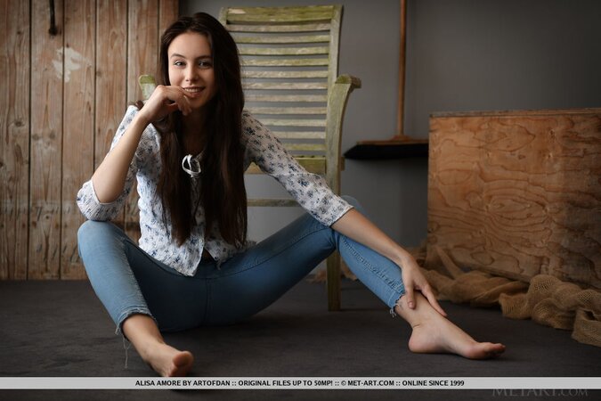 Beautiful brown-eyed teen takes off shirt and jeans at the photo session