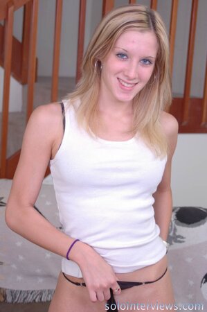 Sweetie with navel piercing and tattoo on lower back touches sensitive pussy