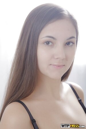 Teen sweetie removes black lingerie and poses on the couch standing on the knees