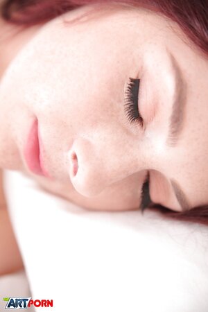 Excited young lady with red hair won't fall asleep until masturbates pussy