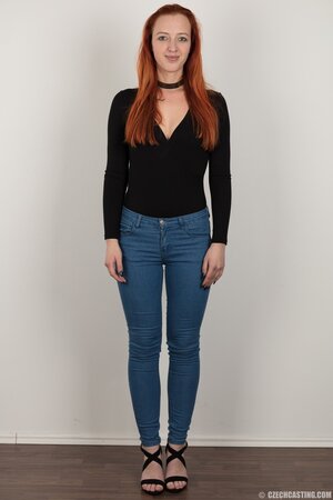 Pale chick with red hair unveils small breasts but doesn't take black panties off