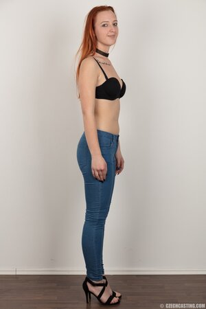 Pale chick with red hair unveils small breasts but doesn't take black panties off