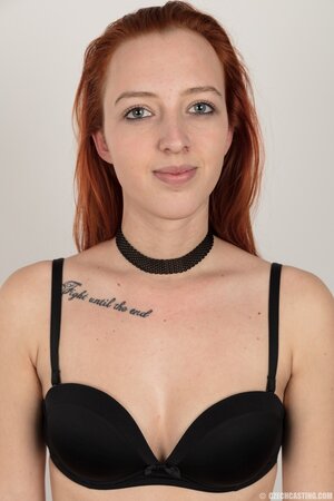 Pale chick with red hair unveils small breasts but doesn't take black panties off