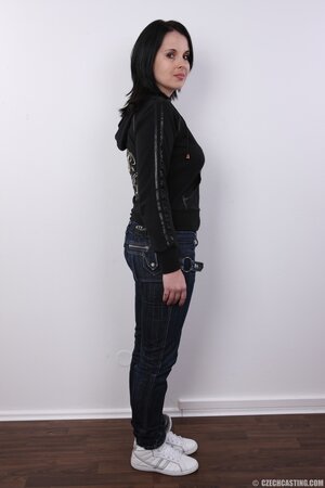 Brunette's pretty face doesn't express emotions when she is posing naked