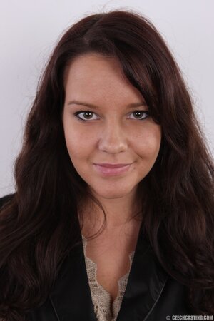 Young woman feels a little bit shy to show off her natural tits on camera