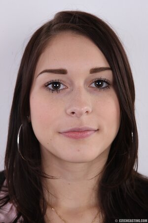 Chick with black eyes unshrouds breasts getting naked in front of the camera