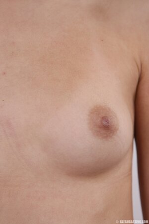 Chick with black eyes unshrouds breasts getting naked in front of the camera