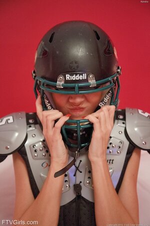 Hot busty football fan takes pink top and panties off and wears uniform