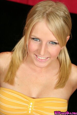 Female with bright eyes doesn't hide her boobs or bald peach from camera