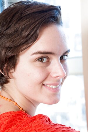 Female takes her dress and green lingerie off dancing with headphones on