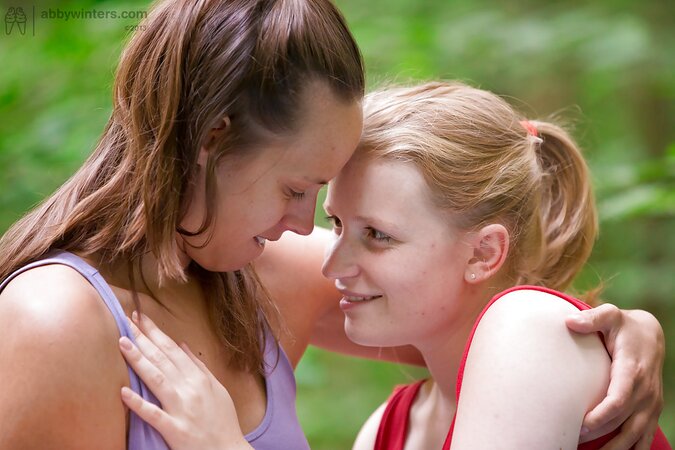 Chick turns each other on and shove their fingers into the cherries outdoors