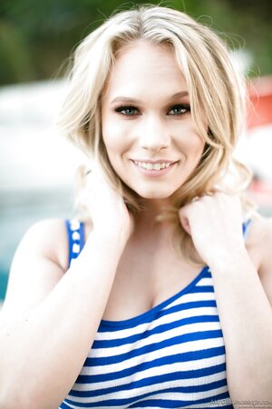 Lascivious young woman in a striped sailor top spreads her pussy lips