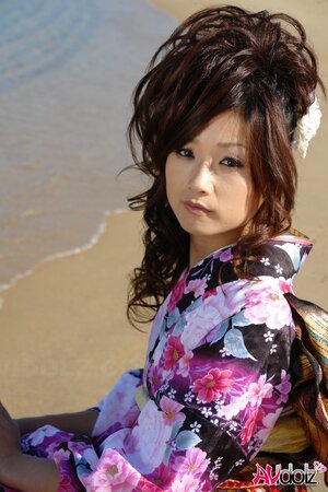 Asian slut knows her business and walks down the ocean shore attracting boys