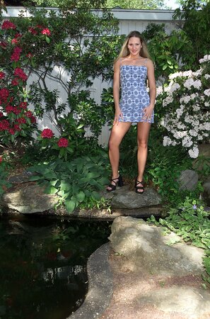 Splendid girl takes off short dress and sits on the bench to masturbate pussy