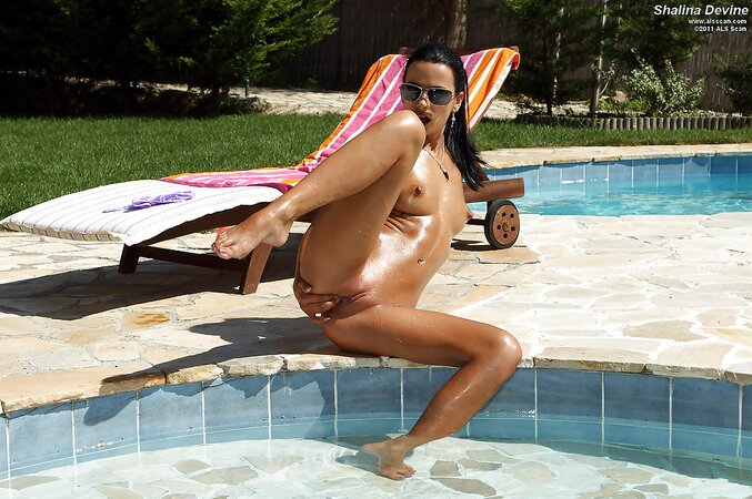 Tanned MILF strips be the pool then masturbates on the lounge chair