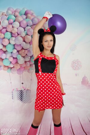 Young teen in cute outfit shows her assets during photoshoot in the studio