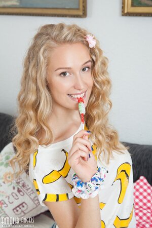 Young Russian woman flashes her small tits and even shaved vagina on a sofa