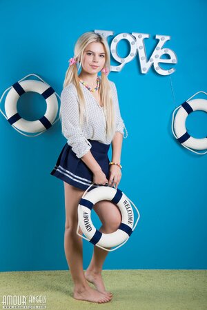 Twin-tailed blonde takes part in nude photoshoot dedicated to the sea theme