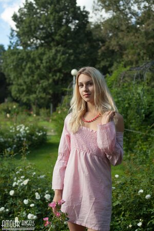 Perfect sunny weather motivates blonde to undress right in public park