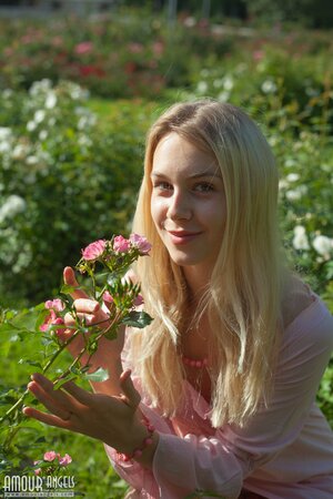 Perfect sunny weather motivates blonde to undress right in public park