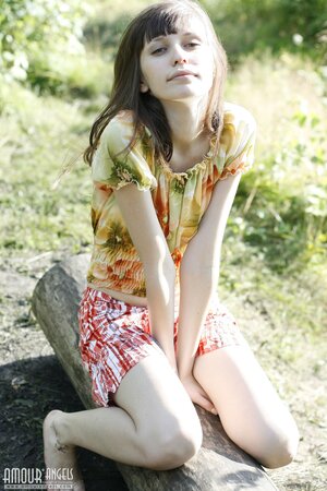 Innocent teen with bangs and slender body flashes tits and pussy by the lake