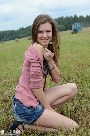 Near stack of hay good-looking teen decides to relax fully naked under the sun