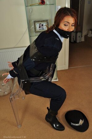 Red-haired female cop during investigation gets tied up to chair by criminal