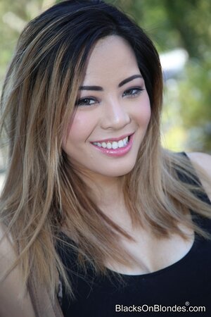 Whore with oriental features welcomes two big black cocks inside her