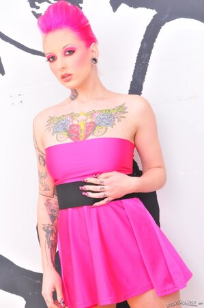 Female with dyed hair and a pink dress on allows her girls to hang and airs cherry