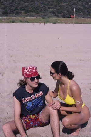 Guy in red bandana plays guitar pretty well but girls are interested in threesome