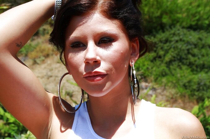 Black-haired lady demonstrates outdoors her perfect butt wrapped in yellow outfit