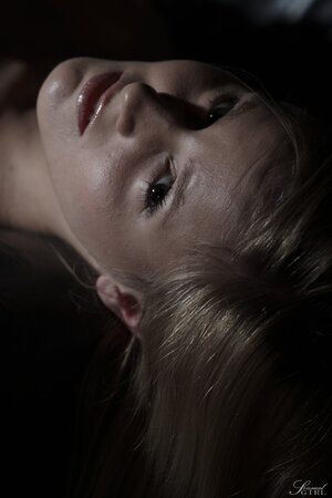 Enticing blonde Kandi seductively poses naked in darkened living room