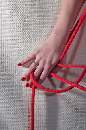 Slender hottie with long legs poses near wall dressed only in stockings