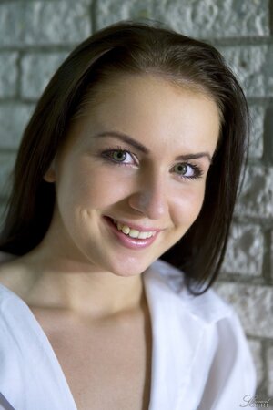 Glamorous schoolgirl in white stockings playfully disrobes and opens pink cunny