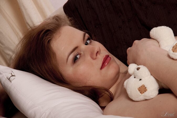 Good-looking girl with red hair spreads legs to boast about shaved pussy