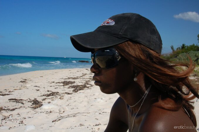 Small-assed black slut with tiny titties gets naked on the rocky shore