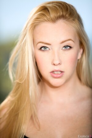 Mesmerizing blonde beauty slowly removes lingerie posing in the nude on the roof