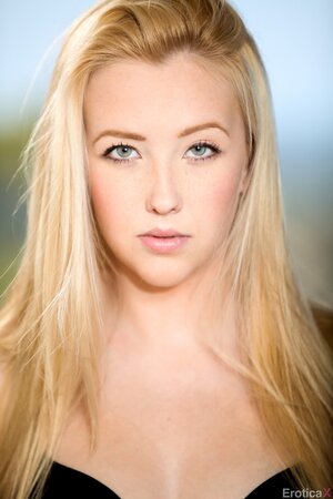 Mesmerizing blonde beauty slowly removes lingerie posing in the nude on the roof